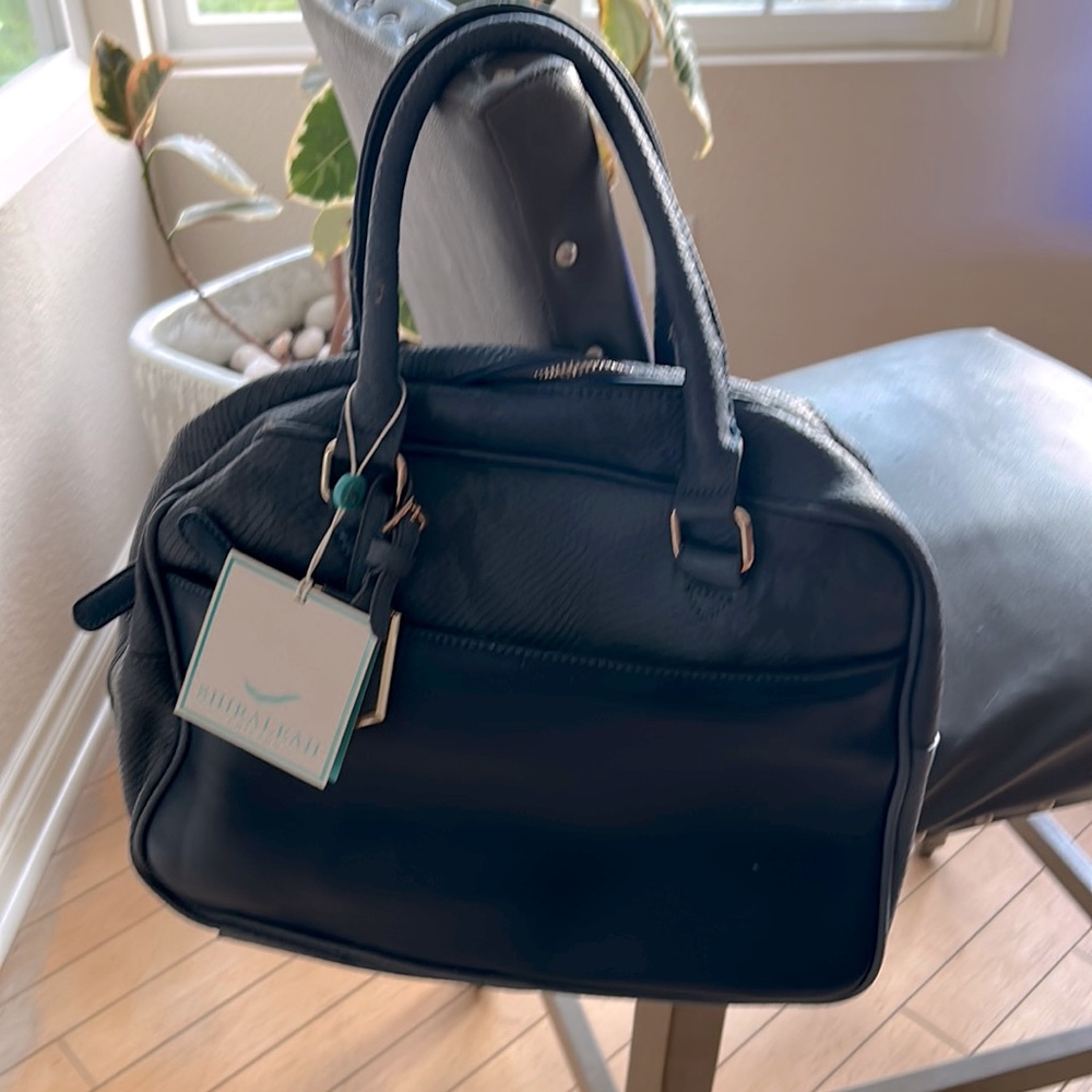 Brand new Shoraleah bag with tags. Has defects due to being stored